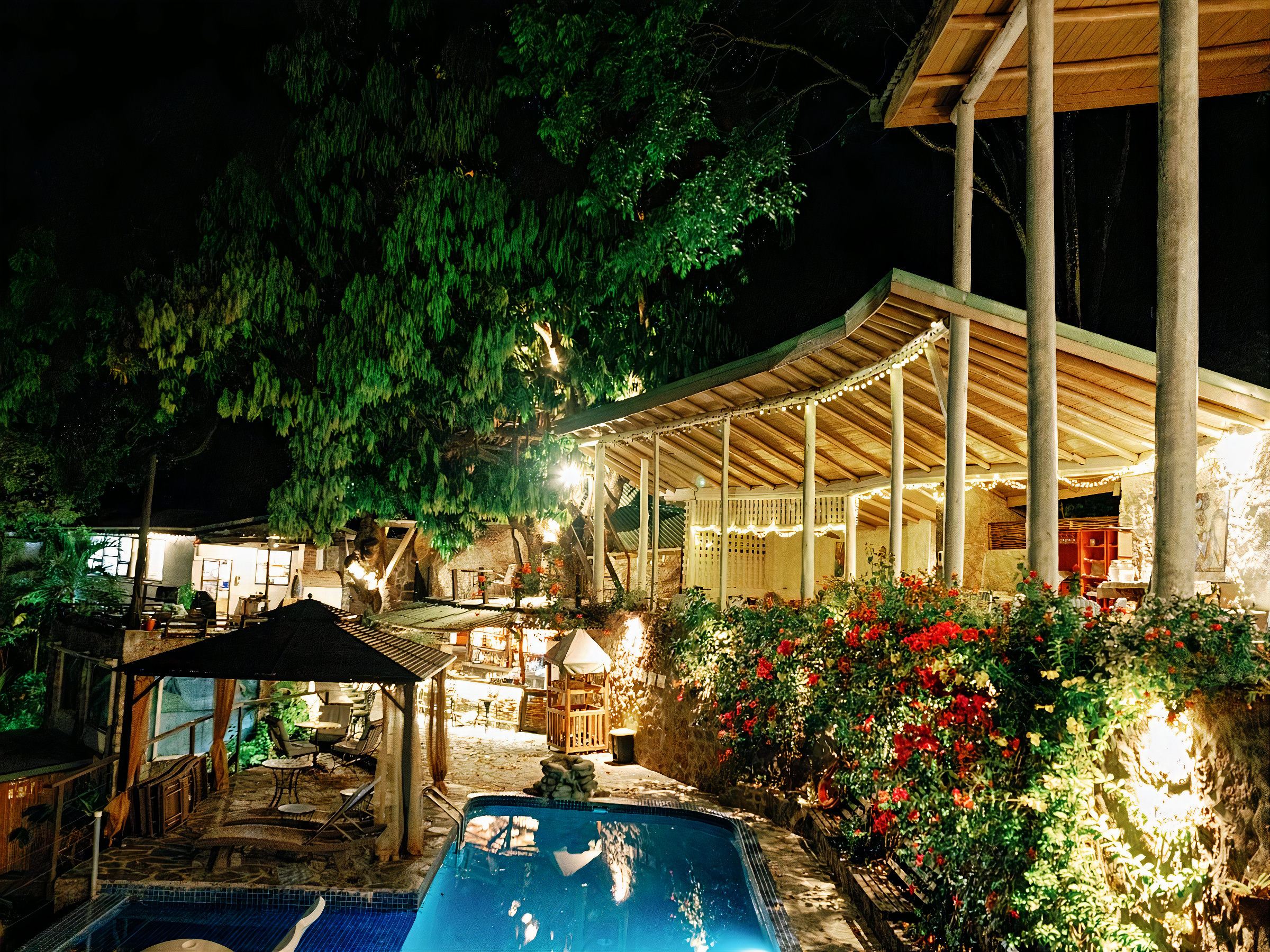 The pool at Green Fig Resort lit up at night