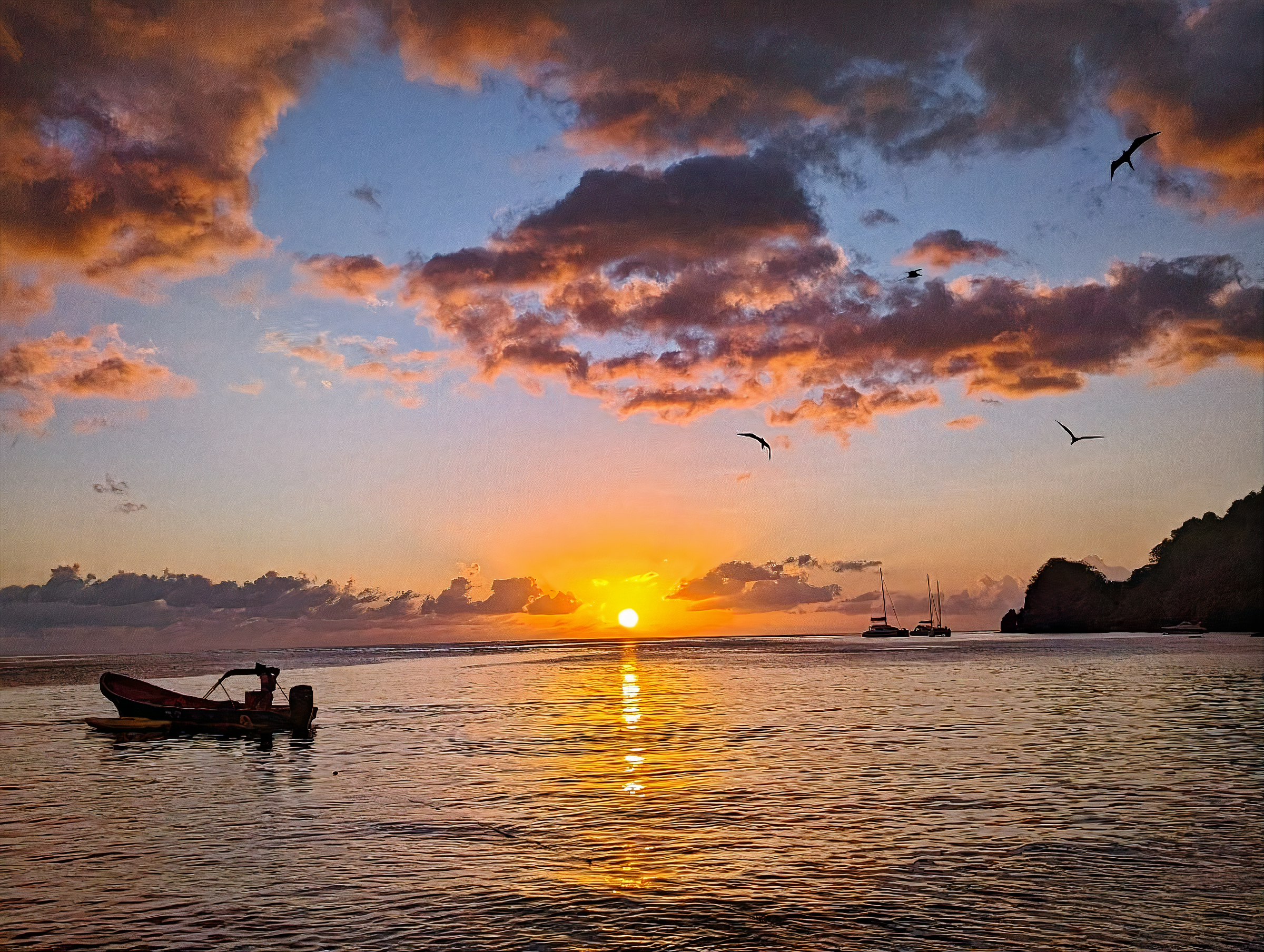 Sunset over Soufrière Bay with a fishing boat
