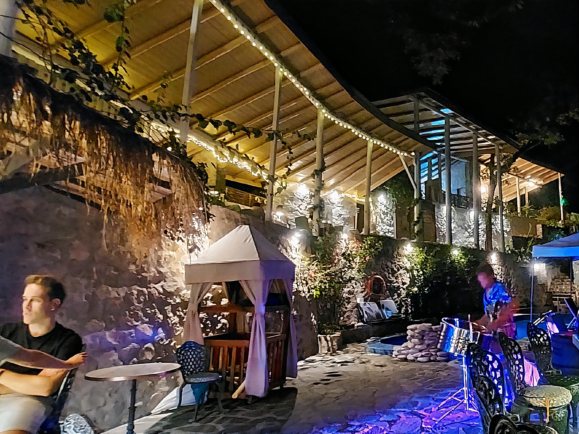 Evening dining under string lights at Saltfish Restaurant